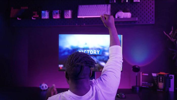 A man playing a PC game and winning. 