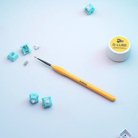 a yellow brush next to small blue objects