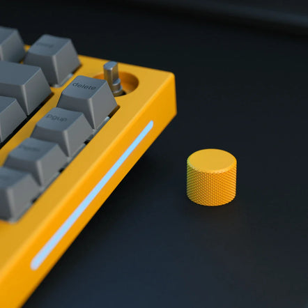 a yellow keyboard next to a yellow knob