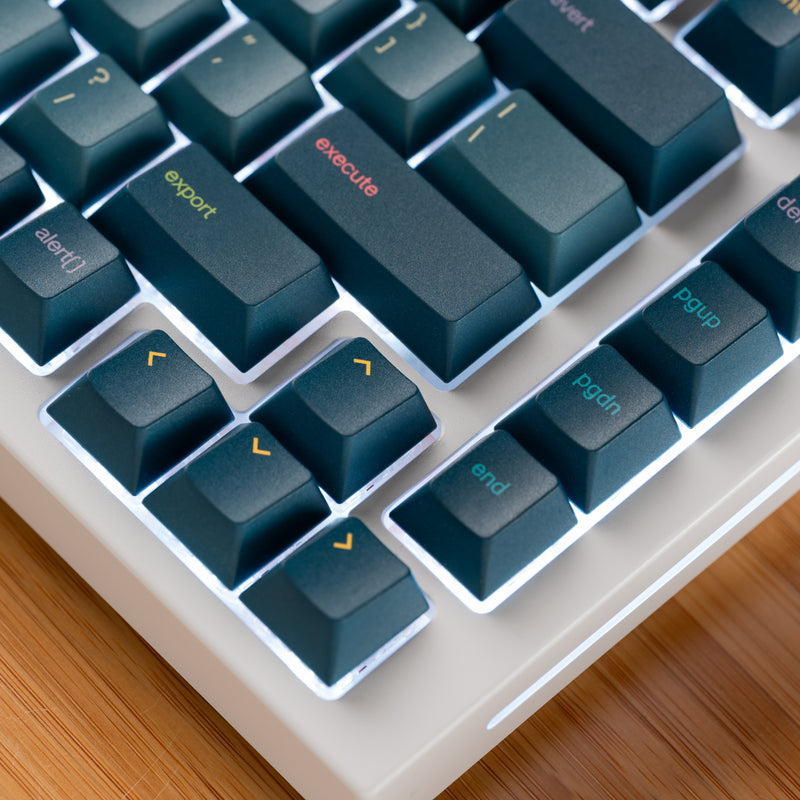Close up of GPBT Code Brew keycaps set on a white GMMK PRO keyboard, showing board's arrow keys