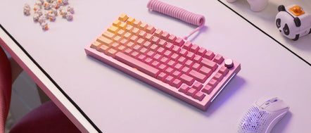 a pink keyboard with a spring attached to it