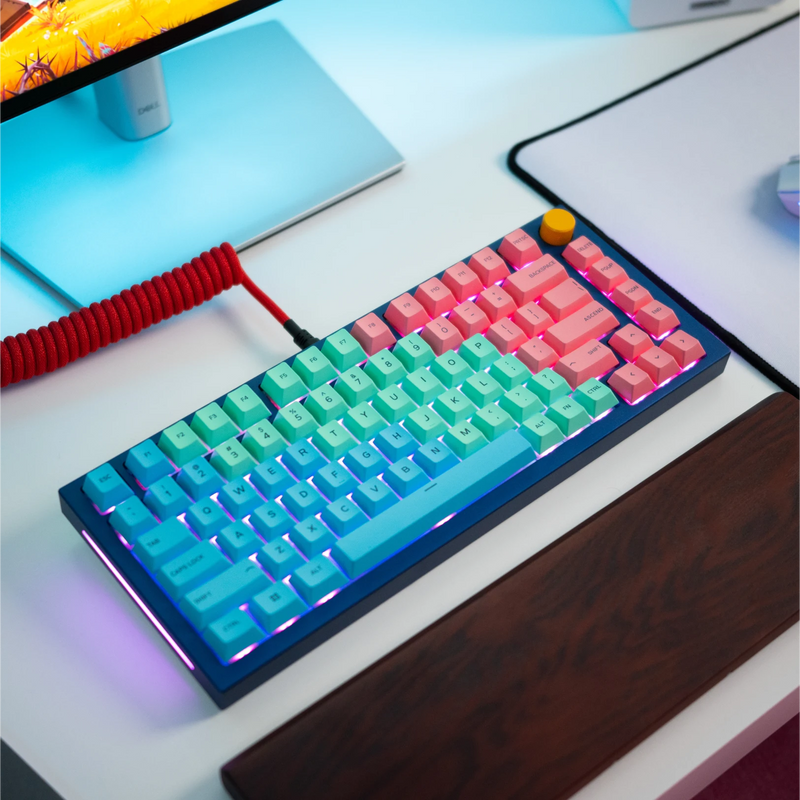 GPBT Pastel keycaps on a GMMK PRO keyboard with Navy Blue top frame, Golden Yellow rotary knob, and Crimson Red coiled cable in a bright desk setup