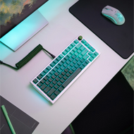 GPBT Rain Forest keycaps on a White Ice GMMK PRO keyboard with a Green rotary Knob and Forest Green coiled cable in a bright white desk setup.