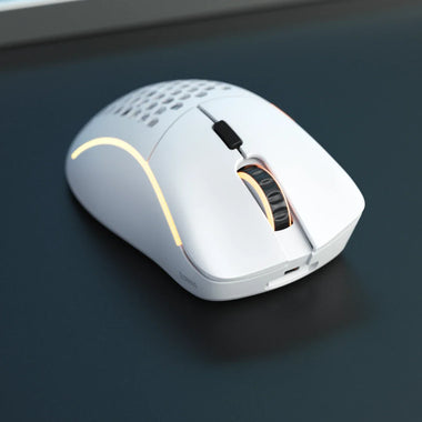 a white computer mouse on a black surface