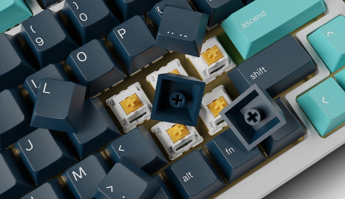 Keycaps flipped over on a keyboard to show their stem mounts