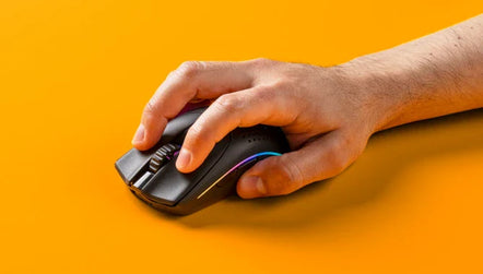 a hand holding a computer mouse