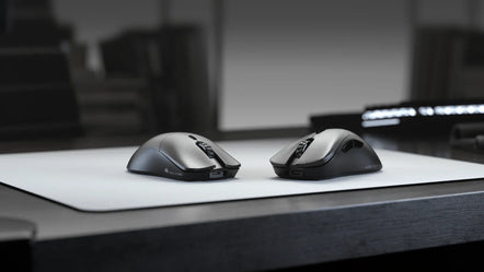 two computer mouses on a table